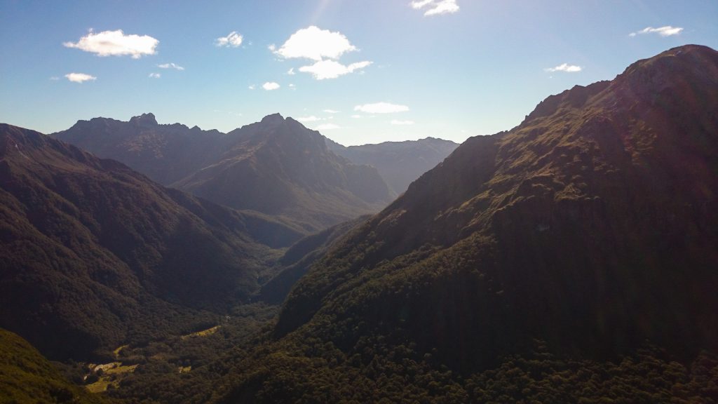 Wanderung Kepler Track - Great Walk, Wanderweg entlang Bergkamm im rauen Gelände, alpin oberhalb Baumgrenze, herrliche Aussicht auf umliegende Berge, herrlicher Sommertag in Neuseeland Südinsel, Fiordland National Park, Wandertag beim Kepler Track