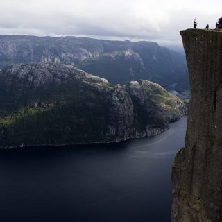 Wanderung zum Pulpit Rock Preikestolen, berühmtester Felsen in Norwegen, Blick auf Pulpit Rock, riesige steile Felswand mit Wanderern, 600 Meter darunter Lysefjord, traumhafte Landschaft