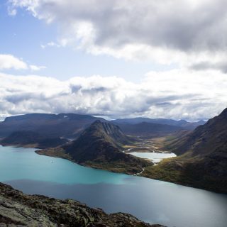 Wanderung Besseggen-Grat im Jotunheimen Nationalpark, Aussicht auf wunderschönen Gjendesee und umgebende Berge, Sonne zaubert traumhafte Farben