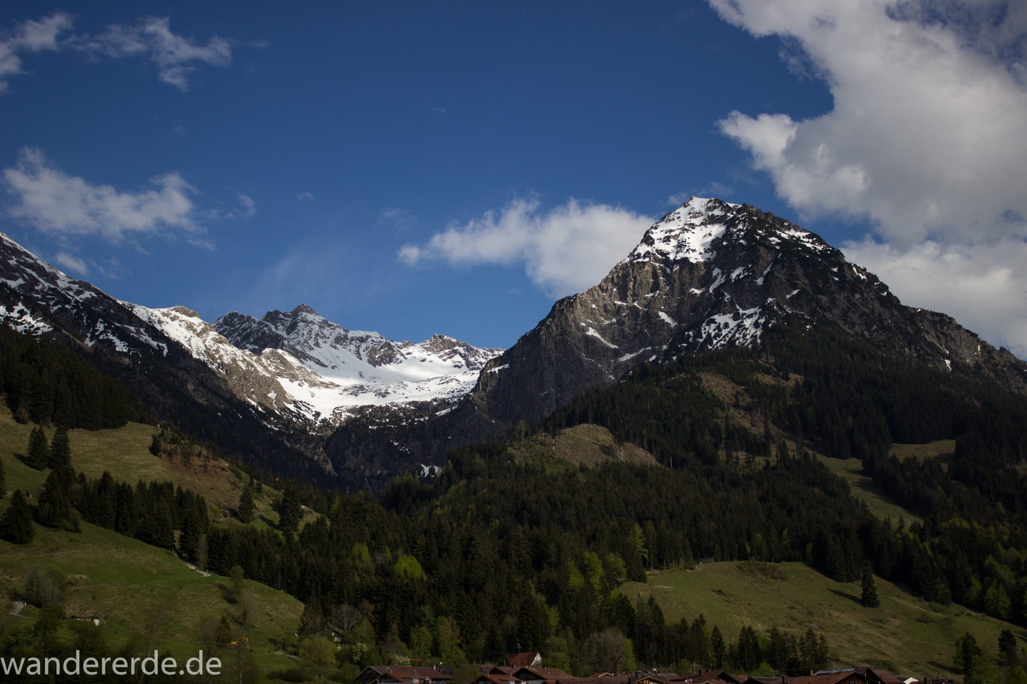 Wanderung Unterer Gaisalpsee, Abschnitt des Wanderwegs von Oberstdorf nach Fischen im Allgäu, Frühling im Allgäu, saftig grüne Wiesen und Wälder, Blick auf Berge mit schneebedeckten Gipfeln