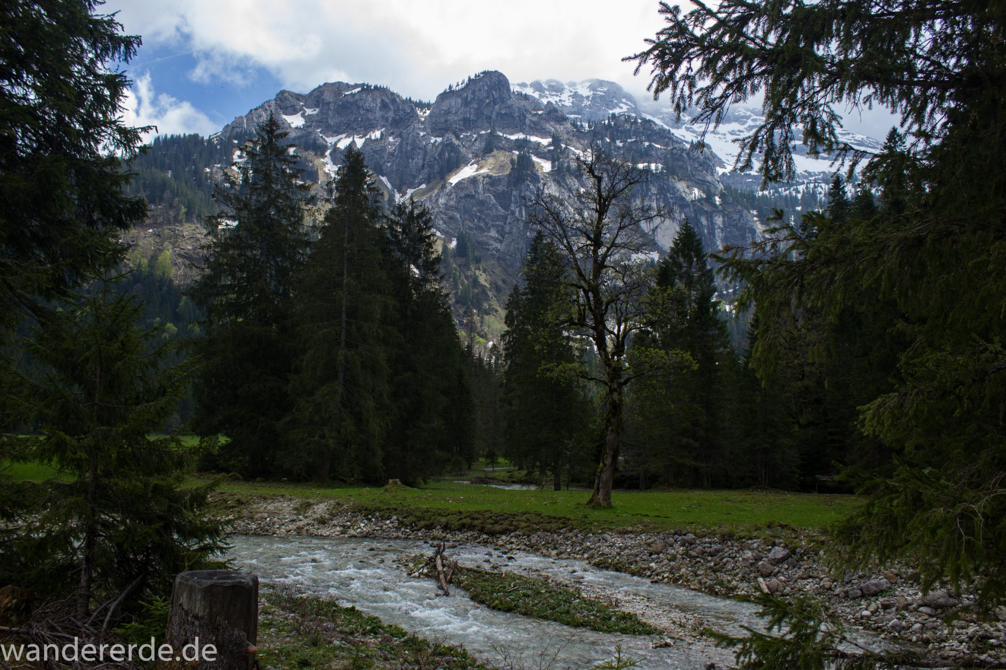Wanderung zur Kenzenhütte in den Ammergauer Alpen, Aussicht auf die Berge, teils schneebedeckte Gipfel in Wolken gehüllt, Frühjahr in den bayerischen Alpen, dichter grüner Wald und saftige Wiesen, Wanderweg oftmals am schönen, idyllischem Bach entlang