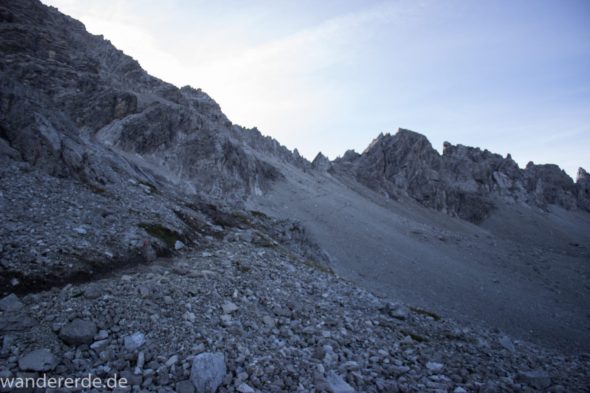 Alpenüberquerung Fernwanderweg E5 Oberstdorf Meran, 3. Etappe von Memminger Hütte zur Skihütte Zams, E5 Wanderweg führt zu Beginn der dritten Etappe ab der Memminger Hütte über steilen und ausgesetzten Wanderweg über die Seescharte, Blick auf sehr schmalen Wanderweg über viel Geröll, Aussicht auf Berge der Alpen