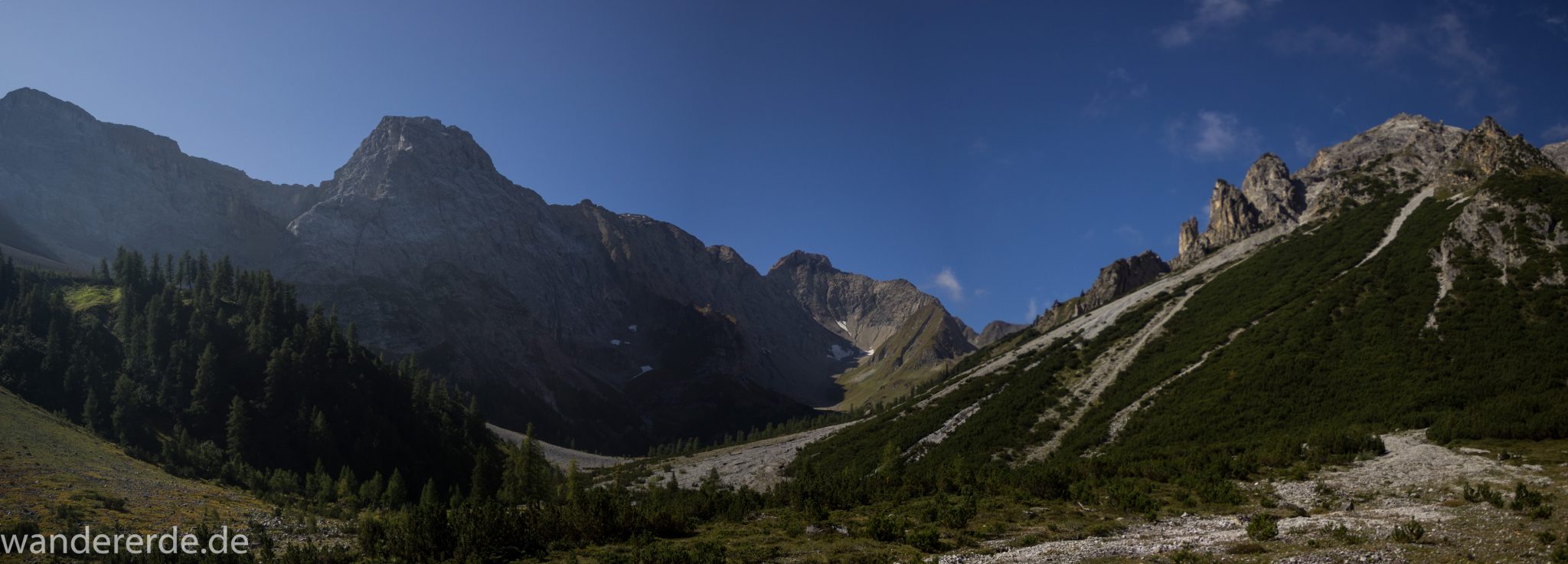 Alpenüberquerung Fernwanderweg E5 Oberstdorf Meran, 3. Etappe von Memminger Hütte zur Skihütte Zams, nach Erreichen der Seescharte folgt ein sehr langer Abstieg ins Lochbachtal auf schmalem Wanderpfad Richtung Zams, Aussicht auf beeindruckende Berge der Alpen und Bergwiesen, grüne Vegetation ist wieder erreicht