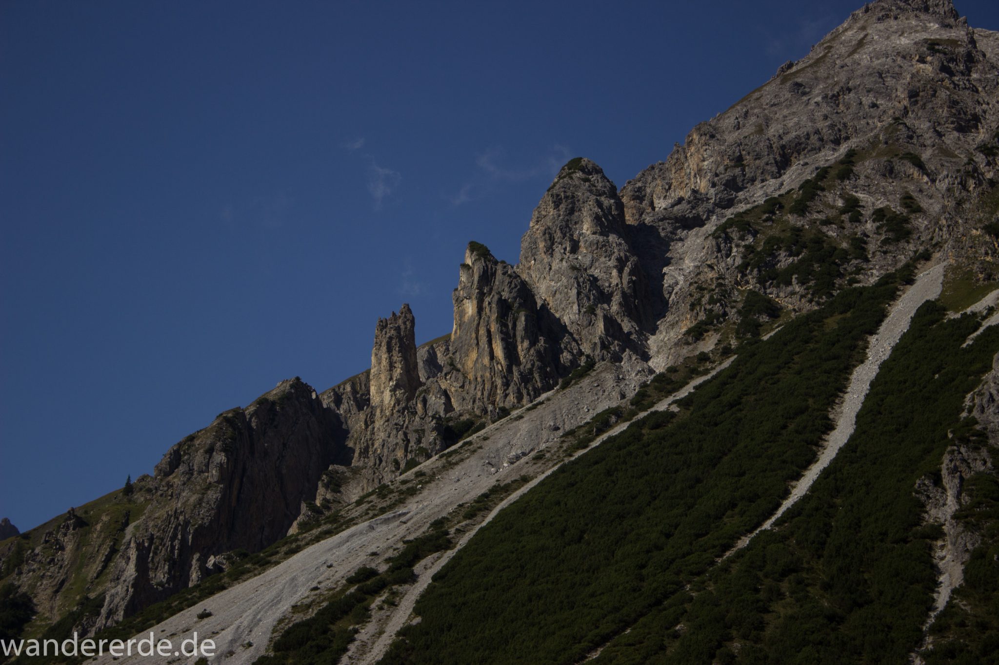 Alpenüberquerung Fernwanderweg E5 Oberstdorf Meran, 3. Etappe von Memminger Hütte zur Skihütte Zams, nach Erreichen der Seescharte folgt ein sehr langer Abstieg auf schmalem Wanderpfad ins Lochbachtal Richtung Zams, Aussicht auf beeindruckende Berggipfel der Alpen, steile, grüne Berghänge