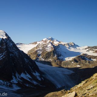 Alpenüberquerung Fernwanderweg E5 Oberstdorf Meran, 5. Etappe von Braunschweiger Hütte zur Martin-Busch-Hütte, zu Beginn der 5. Etappe steiler und schmaler Wanderweg mit viel Geröll hinauf zum Pitztaler Jöchl, Wanderer unterwegs auf Wanderpfad bei schönem Wetter, beeindruckende Berge umgeben einen, teils große Schneefelder in der Nähe der Gipfel