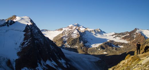 Alpenüberquerung Fernwanderweg E5 Oberstdorf Meran, 5. Etappe von Braunschweiger Hütte zur Martin-Busch-Hütte, zu Beginn der 5. Etappe steiler und schmaler Wanderweg mit viel Geröll hinauf zum Pitztaler Jöchl, Wanderer unterwegs auf Wanderpfad bei schönem Wetter, beeindruckende Berge umgeben einen, teils große Schneefelder in der Nähe der Gipfel
