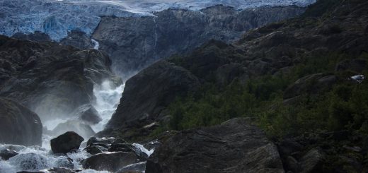 Wandern zum Buarbreen im Folgefonna Nationalpark, Wanderung in der Nähe von Odda mit Aussicht auf den Gletscher Buarbreen und Wasserfälle, Blick auf den Gletscher Buarbreen und den strömenden Fluss, große umliegende Felsen