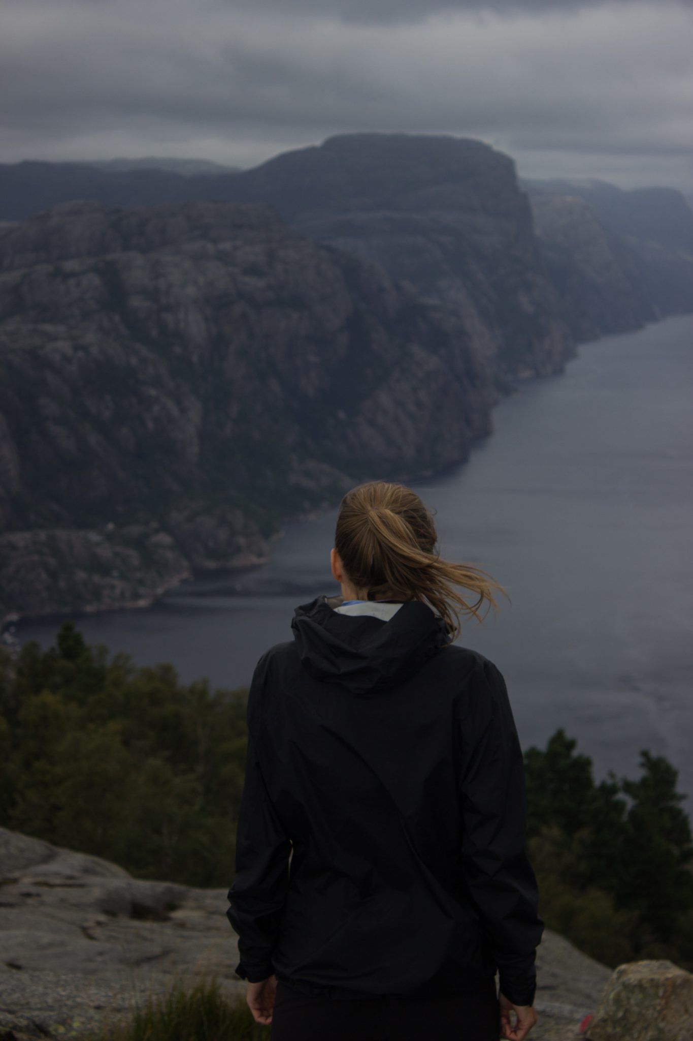 Wanderung beim Lysefjord mit Blick auf den Preikestolen, Startpunkt der Wanderung auf den Sokkaknuten ist beim Lysefjord Hyttegrend, Aussicht auf den Pulpit Rock, Wanderer genießt Aussicht auf den Lysefjord und den Preikestolen