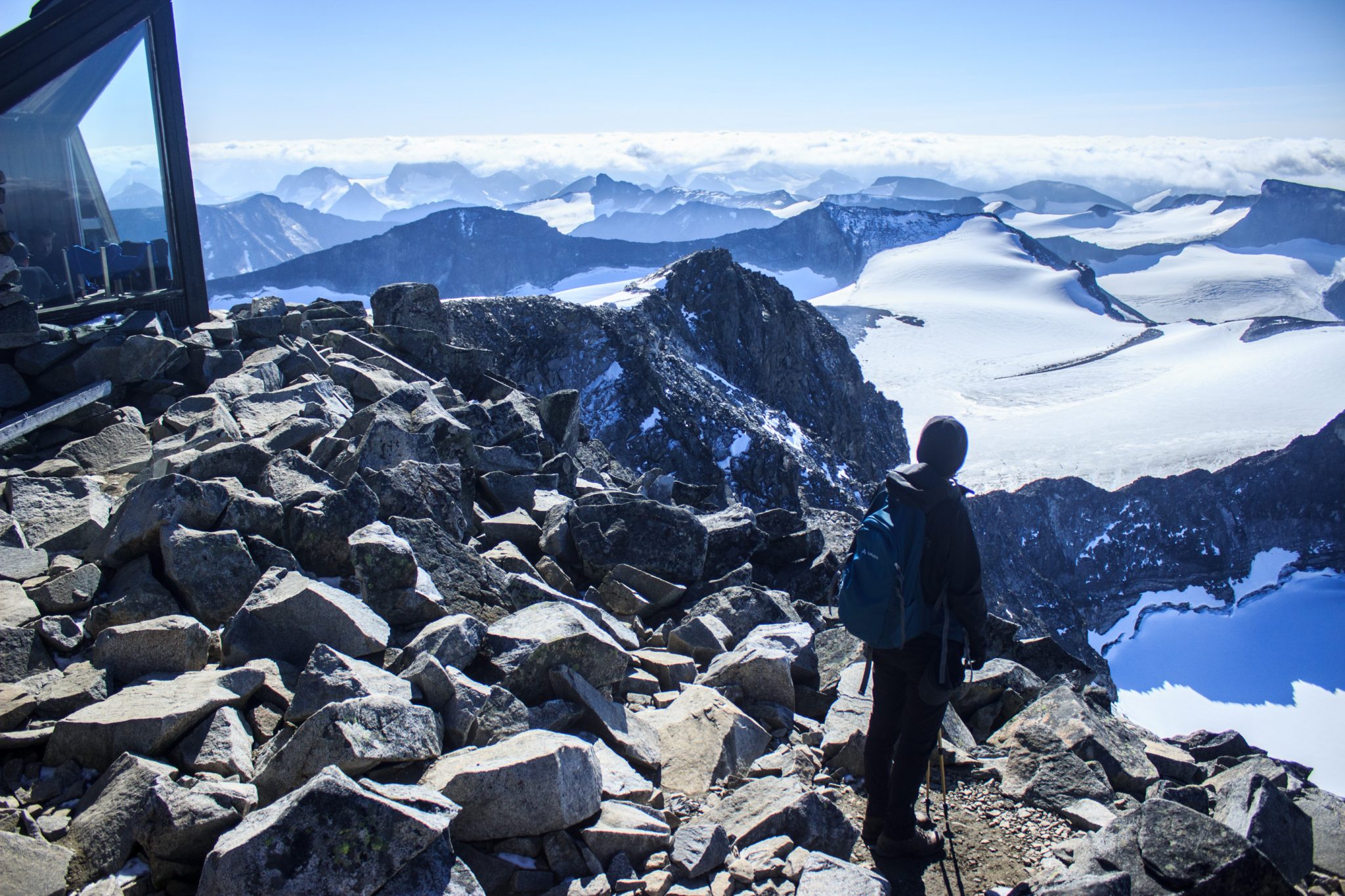 Wanderung auf den höchsten Berg Norwegens - der Galdhøpiggen ab Spiterstulen im Jotunheimen Nationalpark, auch höchster Berg Skandinaviens und Nordeuropas mit 2469 Höhenmetern, Wanderer genießen beeindruckende Aussicht auf die Bergwelt am Gipfel des Galdhøpiggen bei schönstem Sonnenschein